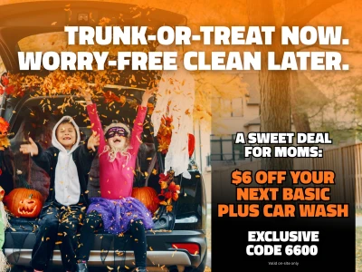 Car ready for Trunk-or-Treat with kids in costumes throwing leaves. Text reads: "Trunk-or-Treat now. Worry-free clean later. A sweet deal for Moms: $6 off your next Basic Plus car wash. Exclusive code 6600 valid on-site only."