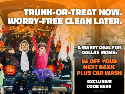 Car ready for Trunk-or-Treat with kids in costumes throwing leaves. Text reads: "Trunk-or-Treat now. Worry-free clean later. A sweet deal for Dallas Moms: $6 off your next Basic Plus car wash. Exclusive code 6600 valid on-site only."