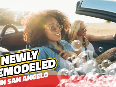 Two women smiling driving a clean car with bubbles. Text reads: "Newly Remodeled in San Angelo"