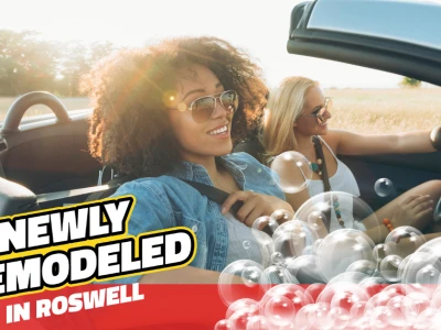 Two women driving in a clean convertible with text that reads "Newly Remodeled in Roswell" and bubble graphic